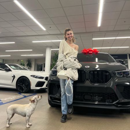 Sydney May took a picture as she sat on the Hood of her 2022 BMW MCOMP x6.